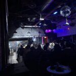 An audience watching Rudy Francisco on stage