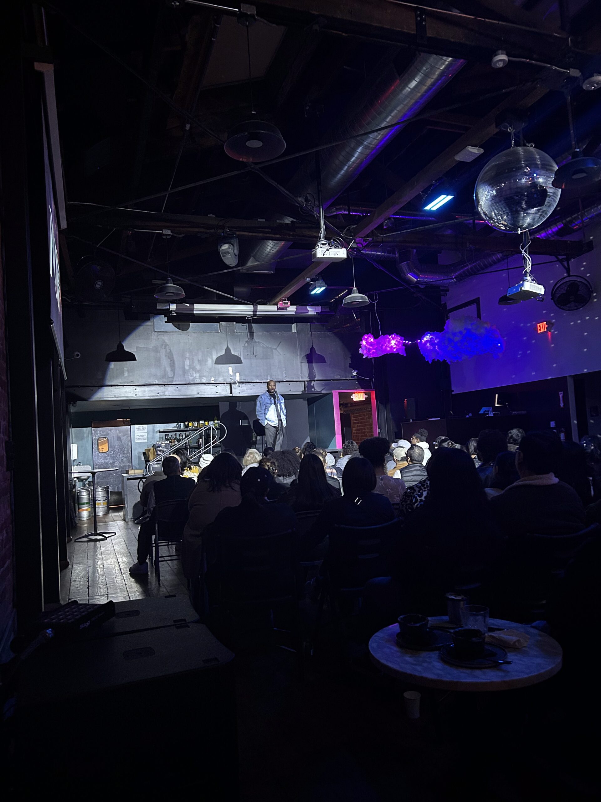 An audience watching Rudy Francisco on stage