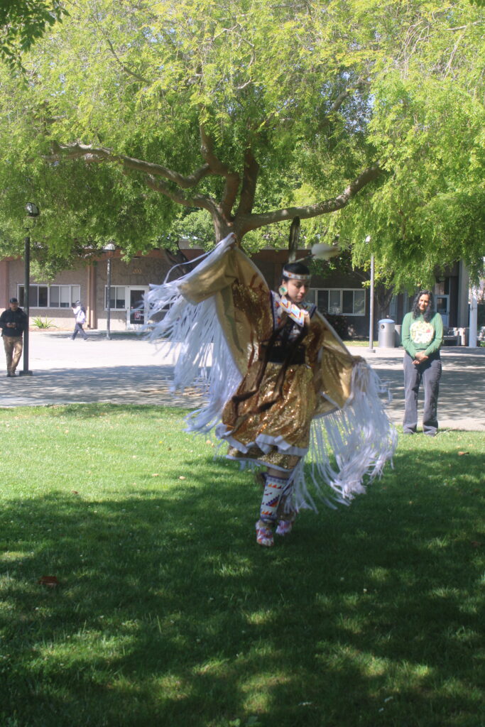 Kiona Young performing a Fancy Shawl dance
