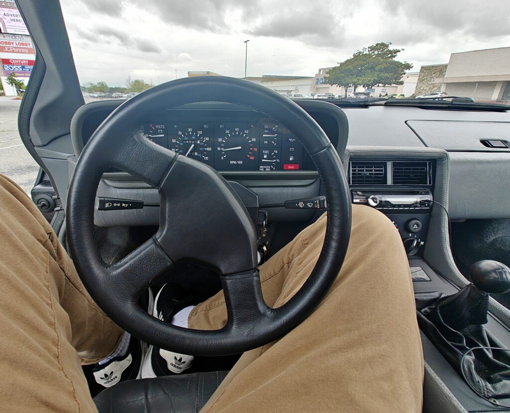 first person view sitting behind steering wheel