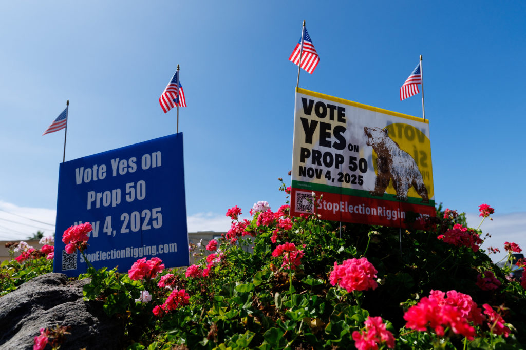 Signs supporting Proposition 50, aimed at countering Republican-led redistricting in Texas by redrawing California's congressional map to favor Democrats, in a residential neighborhood in Encinitas, California