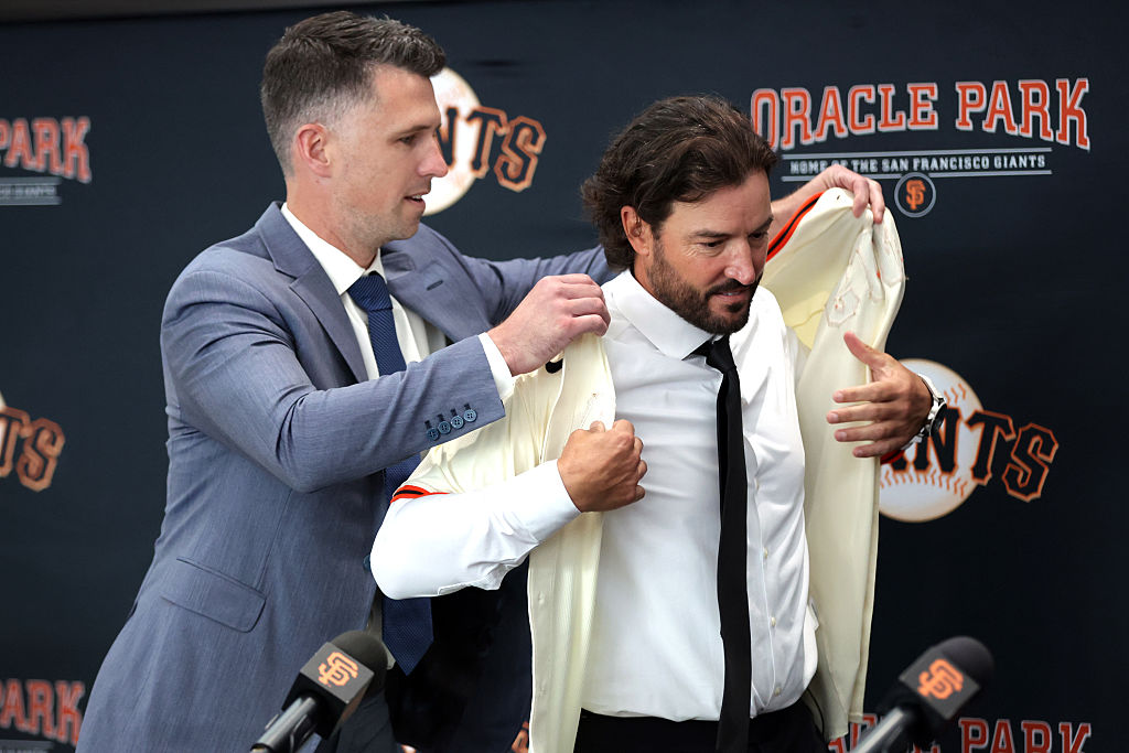 New San Francisco Giants' manager Tony Vitello is helped with putting on a Giants' jersey from by President of Baseball Operations' Buster Posey during introductory press conference at Oracle Park in San Francisco on Thursday, October 30, 2025.