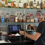 Bartender scanning ID