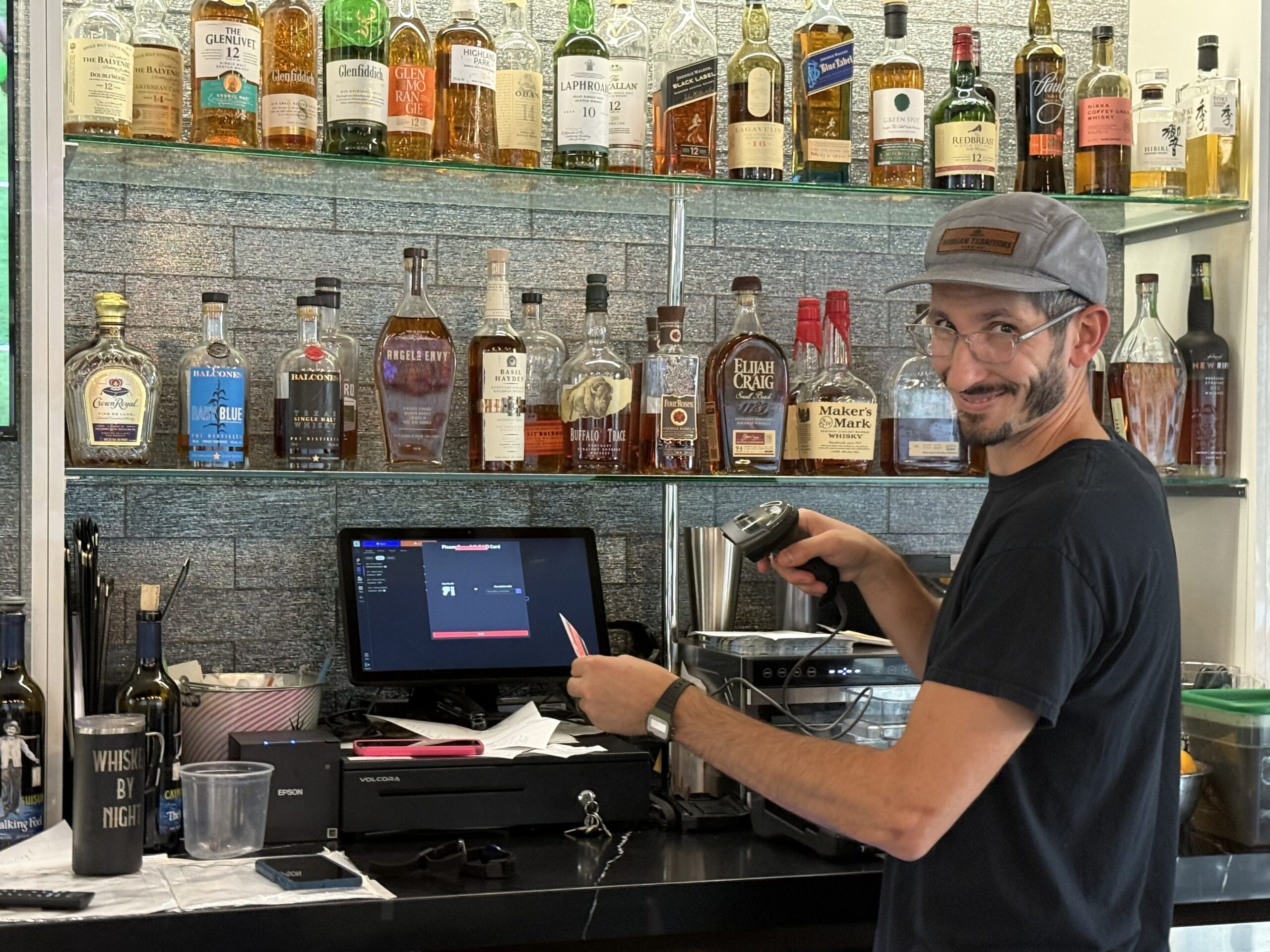 Bartender scanning ID