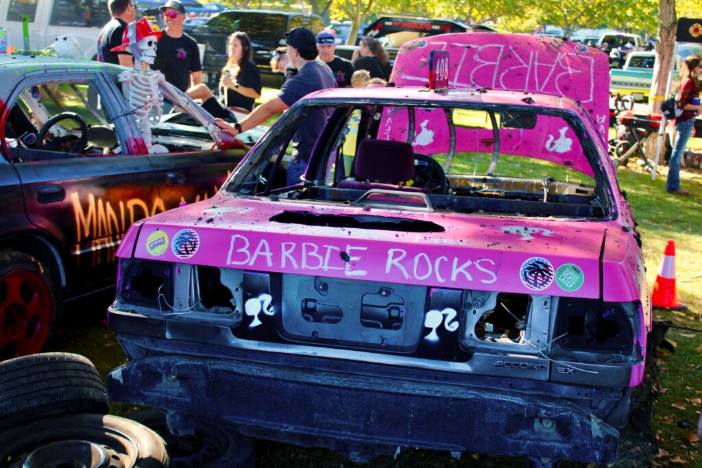 Smashed up car spray painted "Barbie Rocks" on back
