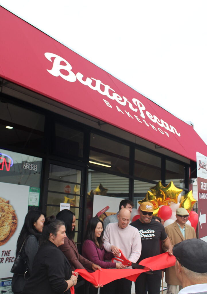 Ribbon cutting in front of bakeshop